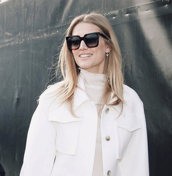 Toni Garrn wearing the gold triangle charm huggie earrings in 14 karat gold. Also available in rose gold and white gold. MOSUO - fine jewelry imbued with life.