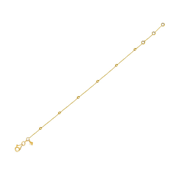 This gold anklet for day to night wear is made of 14 karat gold. The anklet features solid gold balls aligned on a delicate gold chain.