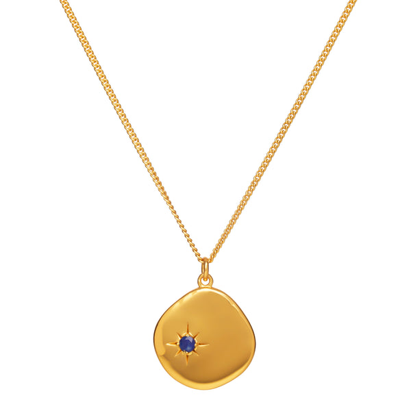 An 18 karat gold vermeil on sterling silver necklace with a lapis lazuli pendant and a long chain.