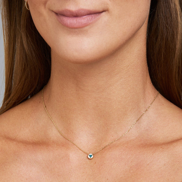 This handmade 14 karat gold necklace is the perfect every day gold accessory.  Its pendant features a hand-painted and two-sided enamel tribal painting symbol. The design allows the necklace to move in anyway, always revealing its beautiful hand-painted side.