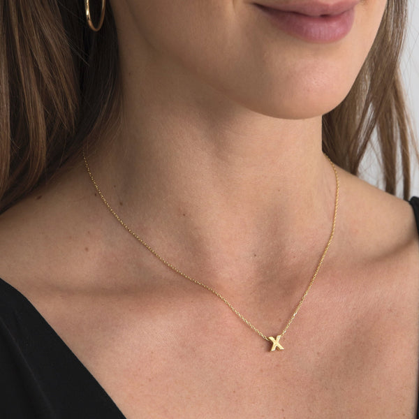 A 18 karat gold vermeil necklace with your initial letter "X". This diamond letter necklace is a special gold necklace that can be worn day and night. A genuine diamond stone in the corner of the letter makes this gold diamond necklace a luxury and ideal gift for yourself, your best friend or loved one.
