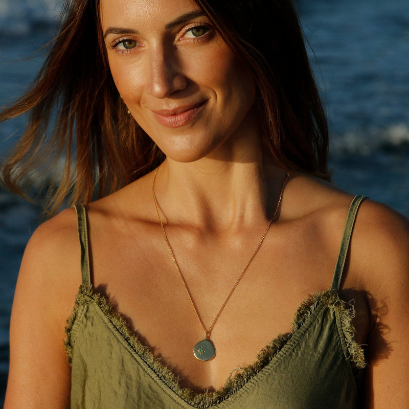 Yellow gold necklace with green onyx stone.