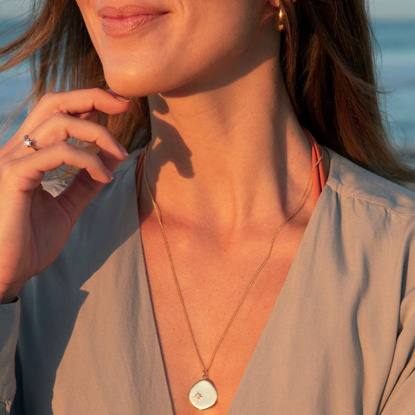 A new universe. The 18 Karat Gold Vermeil Birthstone Necklace shines with its opal stone and long-lasting quality. Wear it as a symbol of your birth month October. This gold necklace is a perfect match for your everyday look. The long chain makes this necklace a perfect layering piece for a vibrant and extravagant look. Opal, the October Birthstone is known as a symbol of hope, purity and love. This gemstone inspires positivity and transformation.